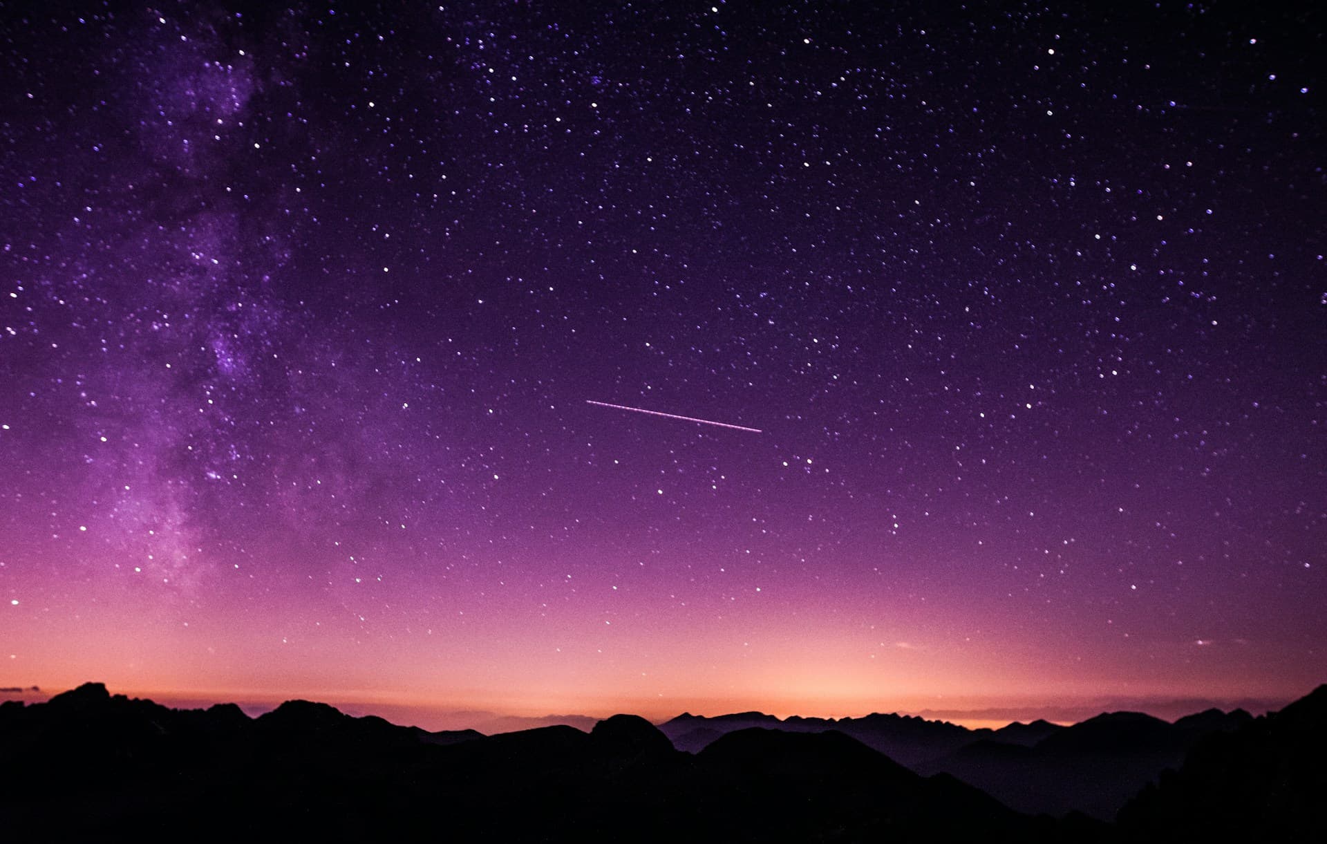 A purple dusk sky over a ridgeline